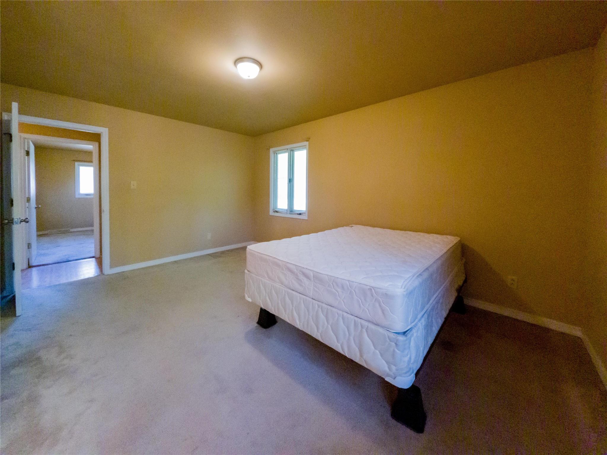 4910 Lakeview Road Charlotte, NC 28216 - Photo 18 of 26 a bedroom with a bed and window