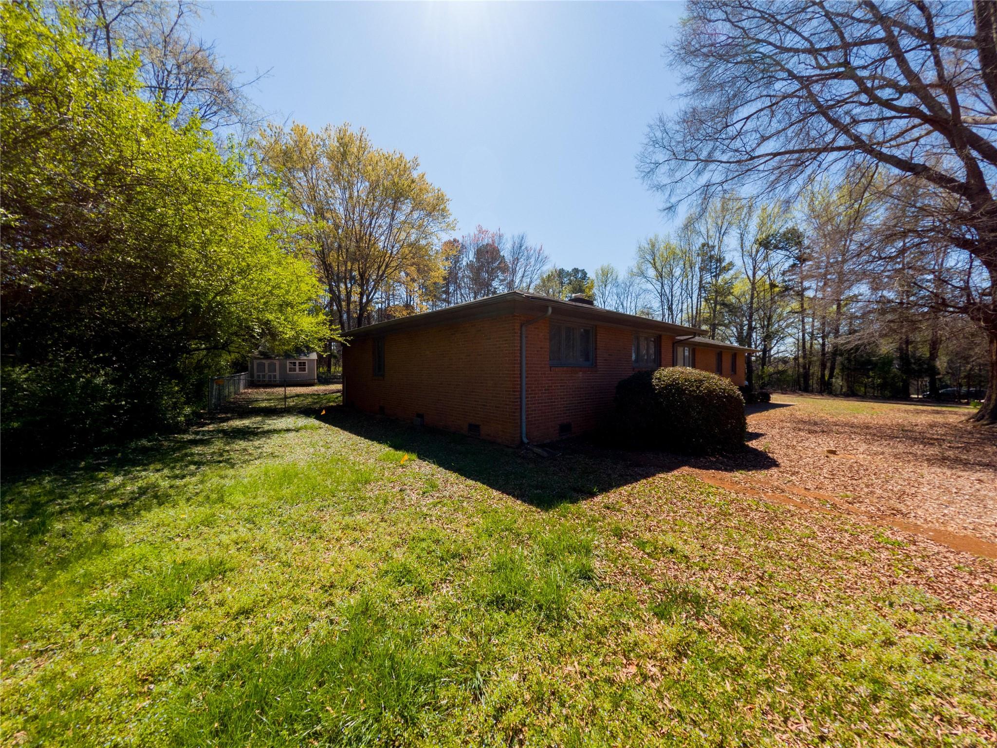 4910 Lakeview Road Charlotte, NC 28216 - Photo 2 of 26 a house with trees in front of it