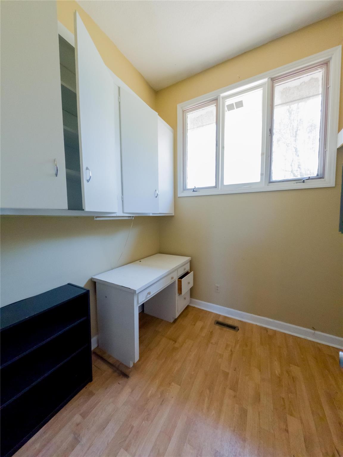 4910 Lakeview Road Charlotte, NC 28216 - Photo 24 of 26 a room with wooden floor and cabinets