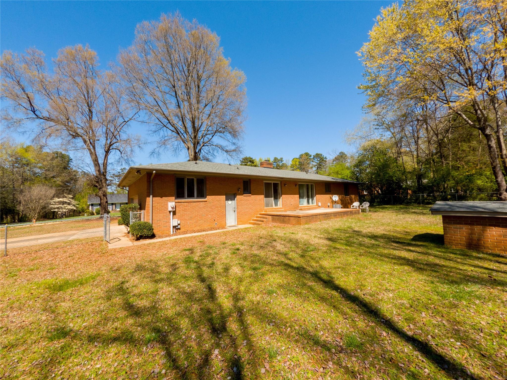 4910 Lakeview Road Charlotte, NC 28216 - Photo 5 of 26 a swimming pool with some trees in the background