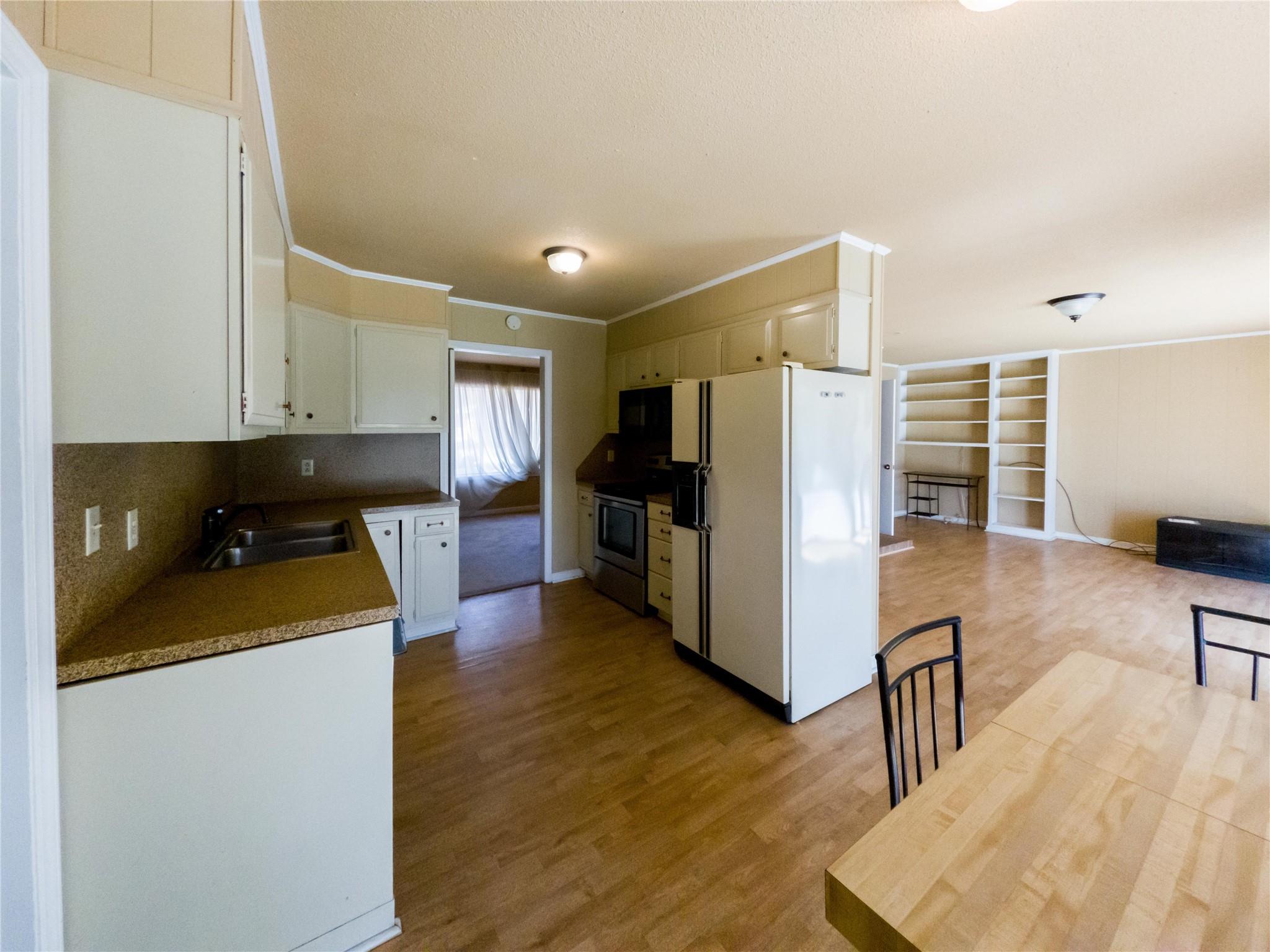 4910 Lakeview Road Charlotte, NC 28216 - Photo 7 of 26 a kitchen with a refrigerator and a stove top oven