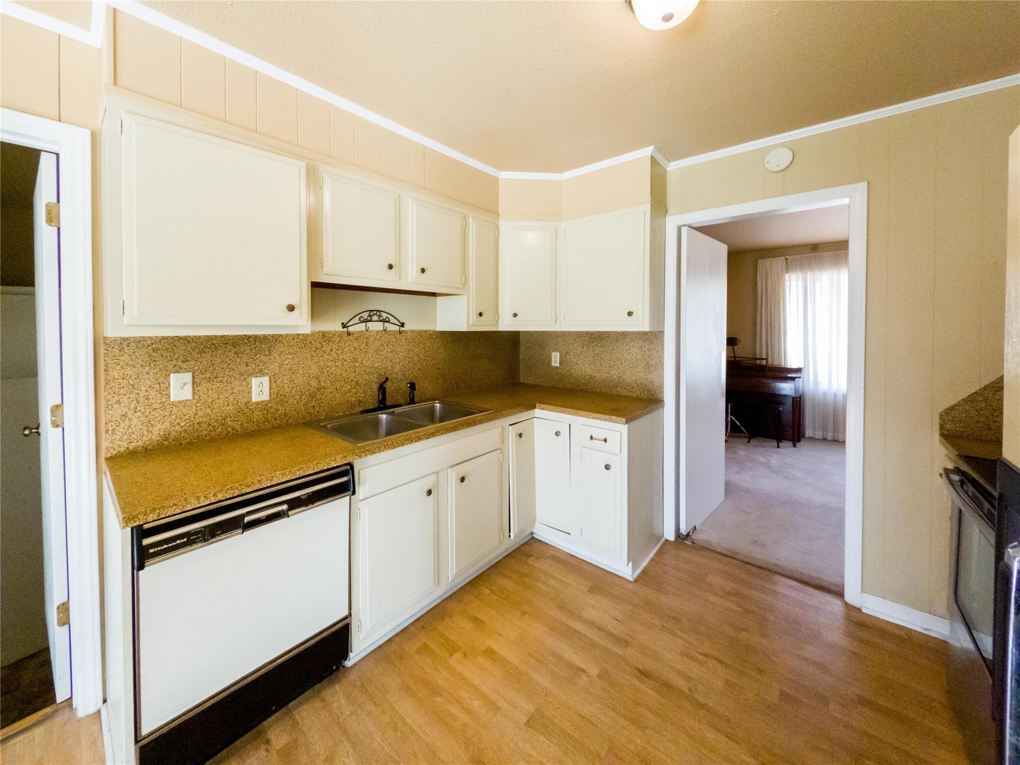 4910 Lakeview Road Charlotte, NC 28216 - Photo 8 of 26 a kitchen with granite countertop white cabinets and white appliances