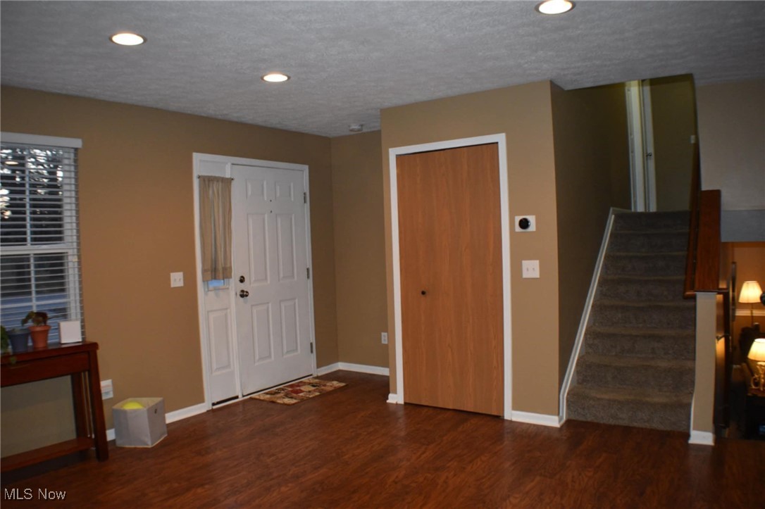 1088 Wadsworth Road Medina, OH 44256 - Photo 9 of 24 Front entry door with coat closet and stairs leading to upper level.