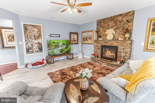 a living room with furniture a fireplace and a flat screen tv