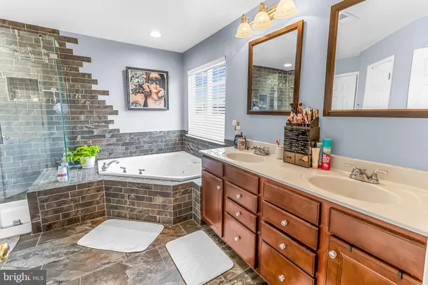 a bathroom with a bathtub and a shower
