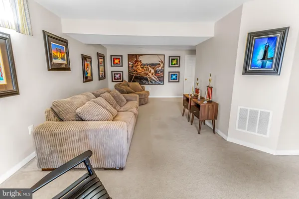 a living room with furniture and a bookshelf