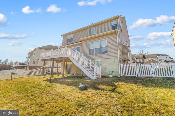 a dining room with large window wooden floor and a chandelier