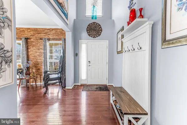 wooden floor with white walls and window
