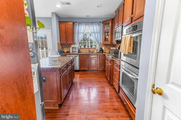 a kitchen with stainless steel appliances granite countertop lots of counter top space