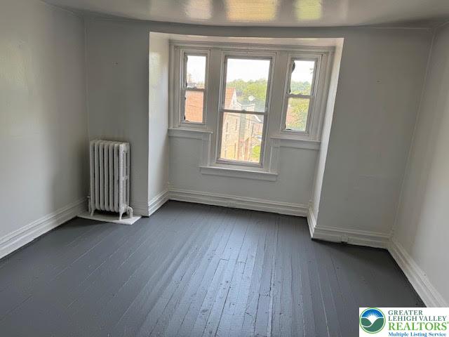 208 Ridge Avenue Allentown, PA 18102 - Photo 13 of 17 an empty room with wooden floor and windows