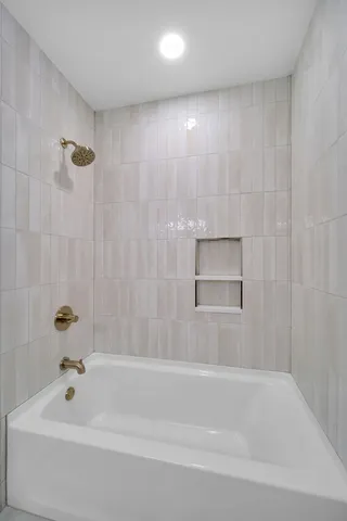 a bathroom with a bathtub and a shower