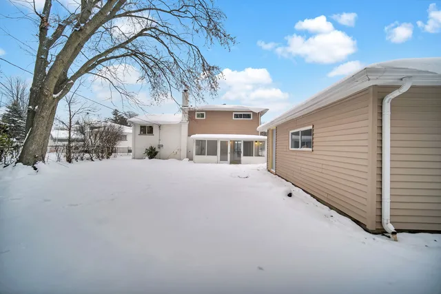 a view of a house with a snow in the yard