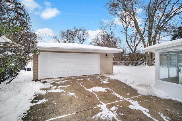 a view of a house with a yard covered in snow