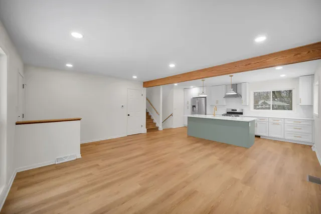 a view of kitchen with microwave and cabinets