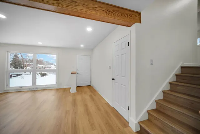 a view of an entryway with wooden floor