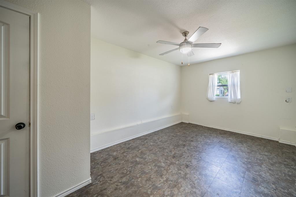 11528 Sinclair Avenue Dallas, TX 75218 - Photo 8 of 16 Neutral-toned walls complement the gray-patterned flooring