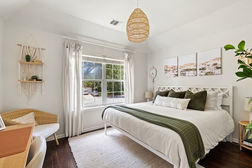 6704 Kiev Cove Austin, TX 78739 - Photo 27 of 37 A tranquil bedroom space featuring rich hardwood floors and a bright window with verdant views.