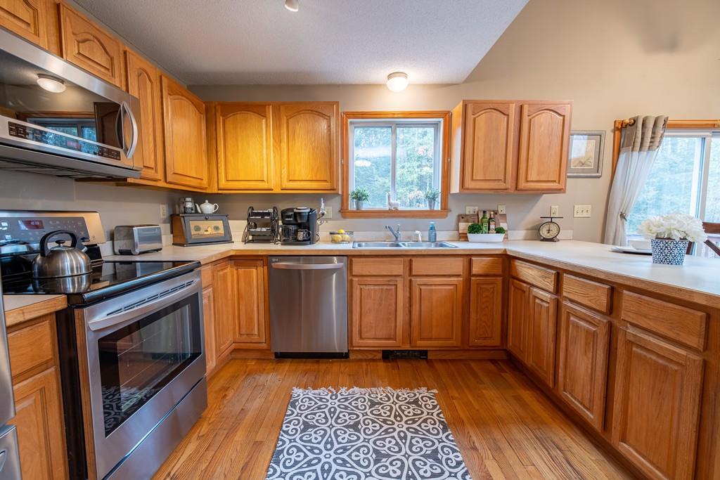 64 Leno Road Holland, MA 01521 - Photo 15 of 36 a kitchen with a sink stove top oven and cabinets