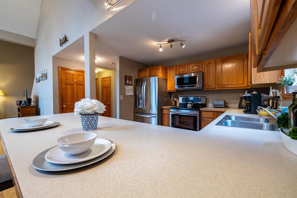 64 Leno Road Holland, MA 01521 - Photo 17 of 36 a kitchen with stainless steel appliances granite countertop a sink a stove and a refrigerator