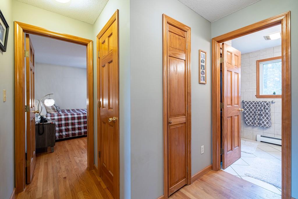64 Leno Road Holland, MA 01521 - Photo 20 of 36 a view of a hallway with wooden floor and cabinet