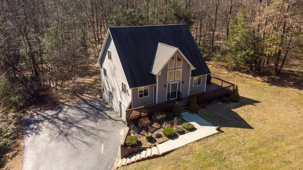64 Leno Road Holland, MA 01521 - Photo 2 of 36 a view of a small house with yard and sitting area