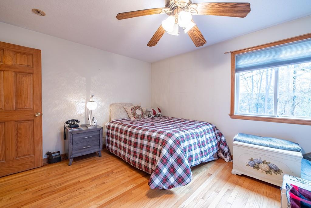 64 Leno Road Holland, MA 01521 - Photo 21 of 36 a bedroom with a bed and a chandelier