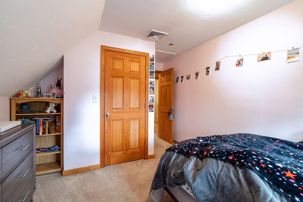 64 Leno Road Holland, MA 01521 - Photo 25 of 36 a bedroom with a bed and a book shelf