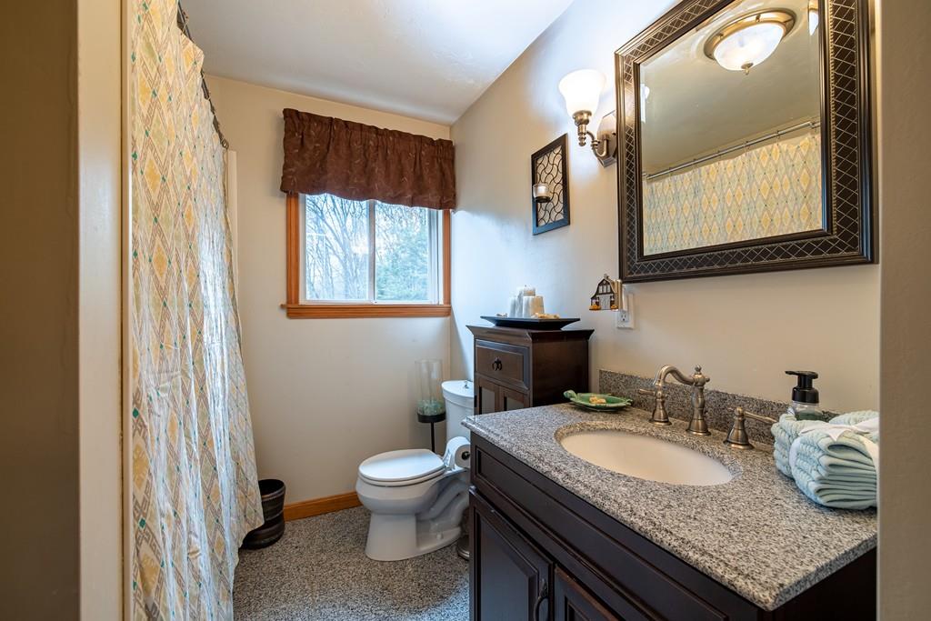 64 Leno Road Holland, MA 01521 - Photo 26 of 36 a bathroom with a granite countertop sink and a toilet