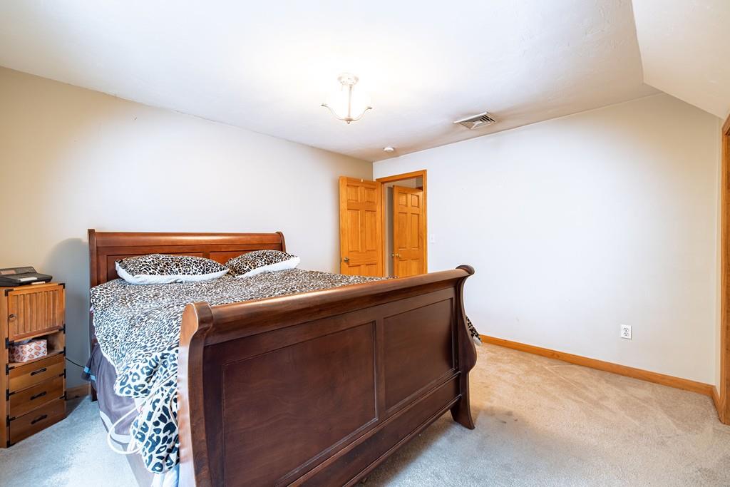 64 Leno Road Holland, MA 01521 - Photo 29 of 36 a bed sitting in a room next to a window