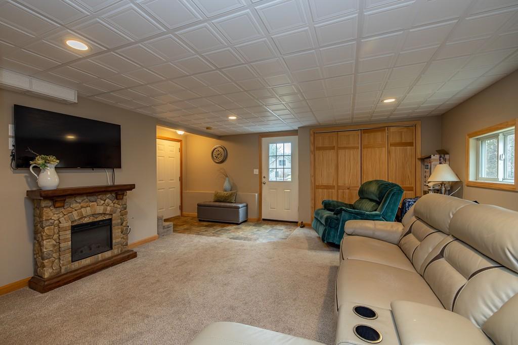 64 Leno Road Holland, MA 01521 - Photo 31 of 36 a living room with furniture a fireplace and a flat screen tv