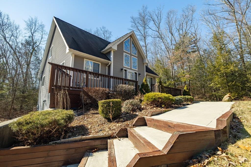 64 Leno Road Holland, MA 01521 - Photo 10 of 36 a view of a house with backyard and sitting area