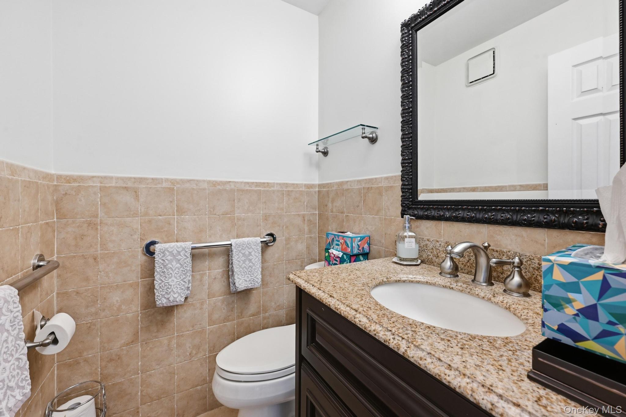 19 Sunset Road West Albertson, NY 11507 - Photo 10 of 24 Vanity featuring a polished stone countertop, undermount sink, and brushed nickel faucet