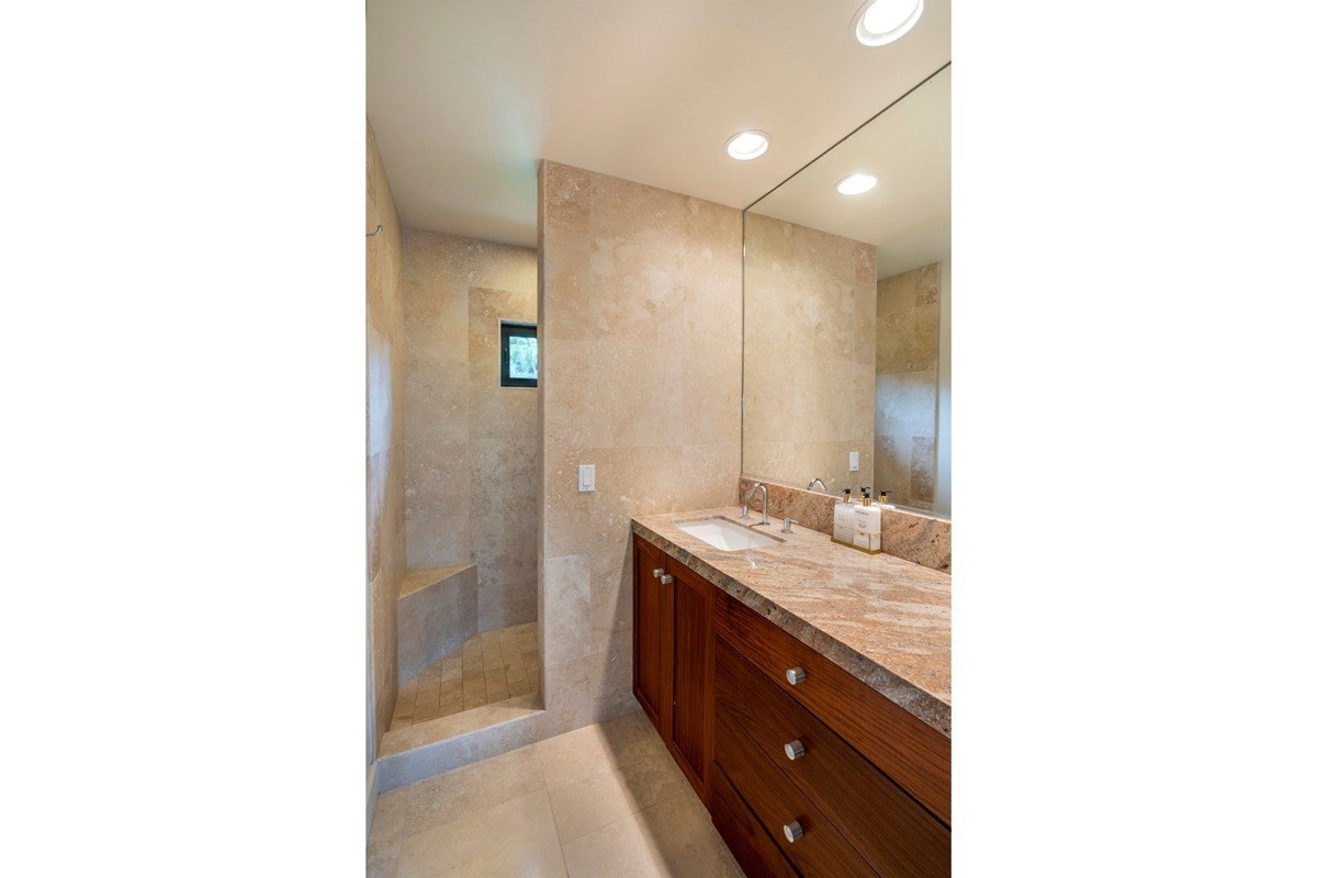 4318 Punee Road Koloa, HI 96756 - Photo 11 of 23 a bathroom with a granite countertop sink a mirror and a shower