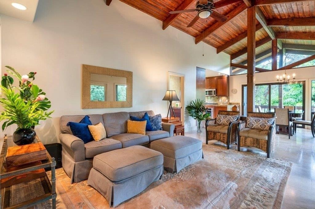 4318 Punee Road Koloa, HI 96756 - Photo 2 of 23 a living room with furniture a chandelier and a dining table