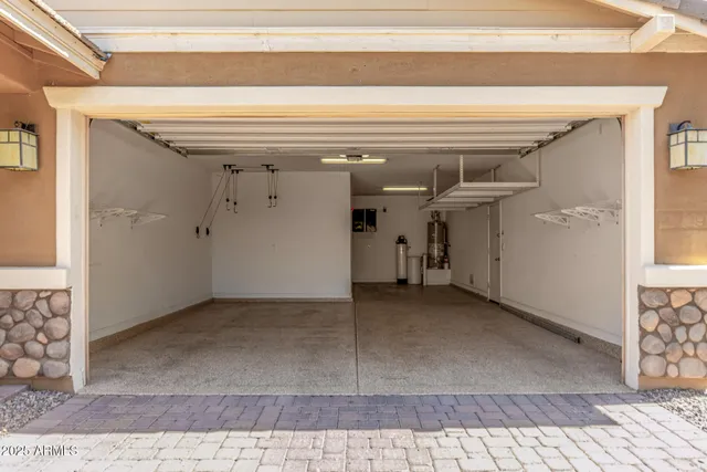 a kitchen with stainless steel appliances granite countertop a sink a stove and a refrigerator