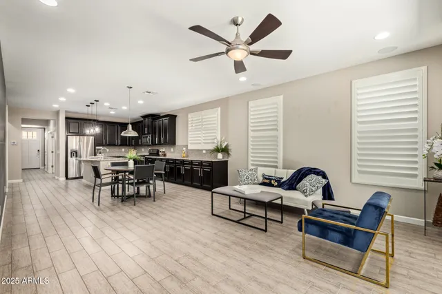 a view of a house with backyard and sitting area