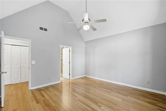 a view of an empty room with wooden floor