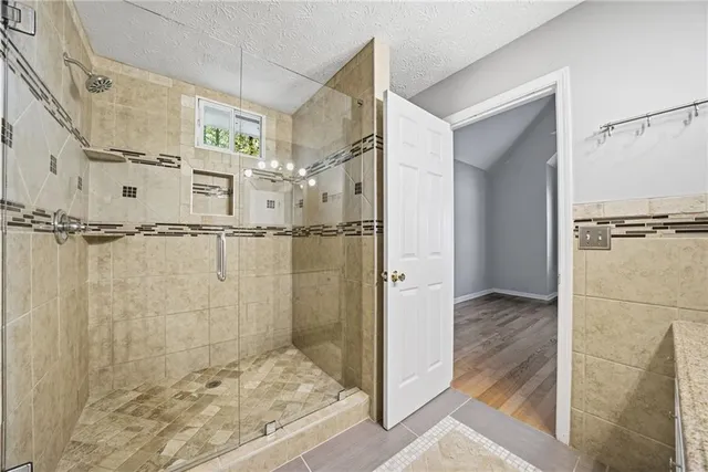 a bathroom with a shower and a glass door