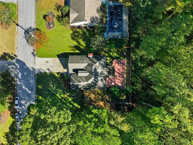 an aerial view of a house with a yard basket ball court and outdoor seating