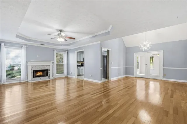 a view of empty room with wooden floor and fireplace