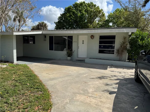 a backyard of a house with a garden and plants