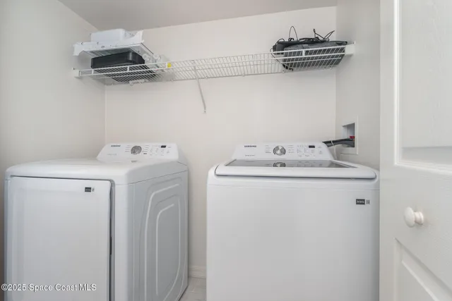 a kitchen with granite countertop white cabinets white appliances a sink and a window
