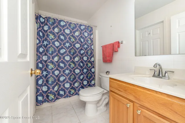 a view of a kitchen with refrigerator and window