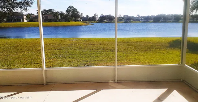 a view of an empty room with a large windows with outer view