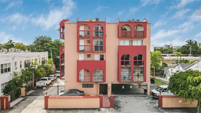 a front view of a multi story residential apartment building with yard