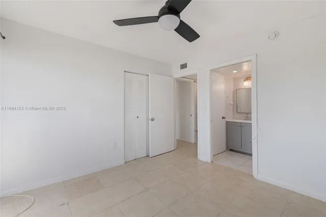 a view of an empty room and a ceiling fan
