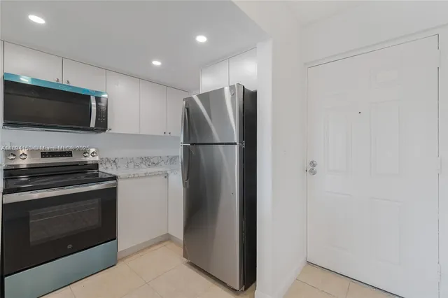 a kitchen with a refrigerator stove and microwave