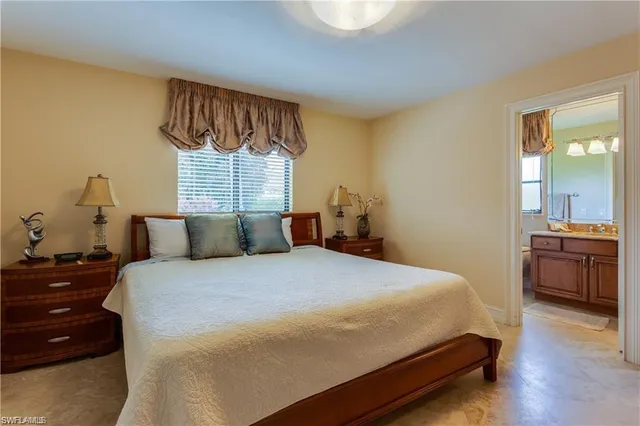 a bedroom with a bed and a view of kitchen