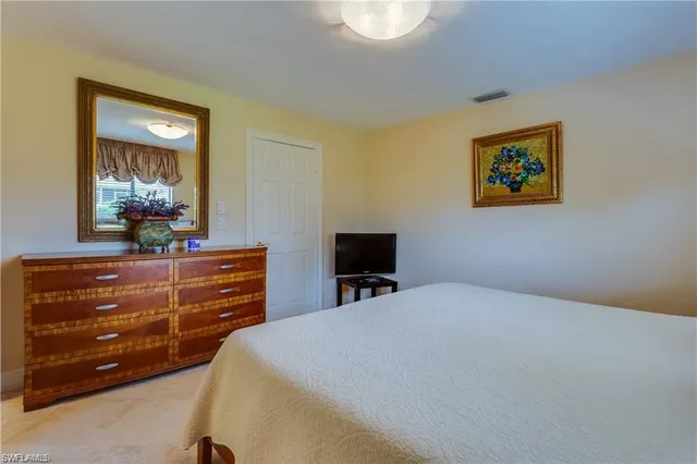 a bed room with a bed and a mirror