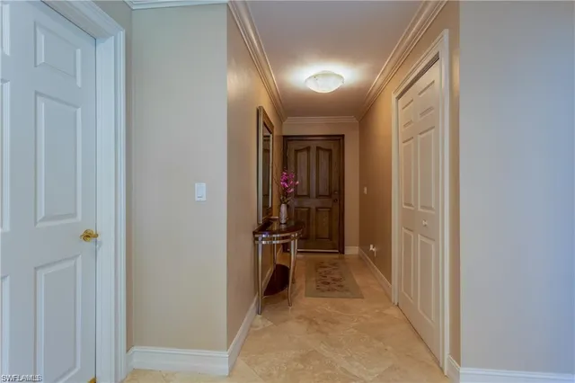 a view of a hallway with wooden shelves